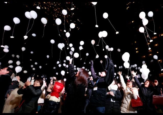 Revellers release balloons as they take part in New Year celebrations in Tokyo, Japan, January 1, 2017. REUTERS/Issei Kato